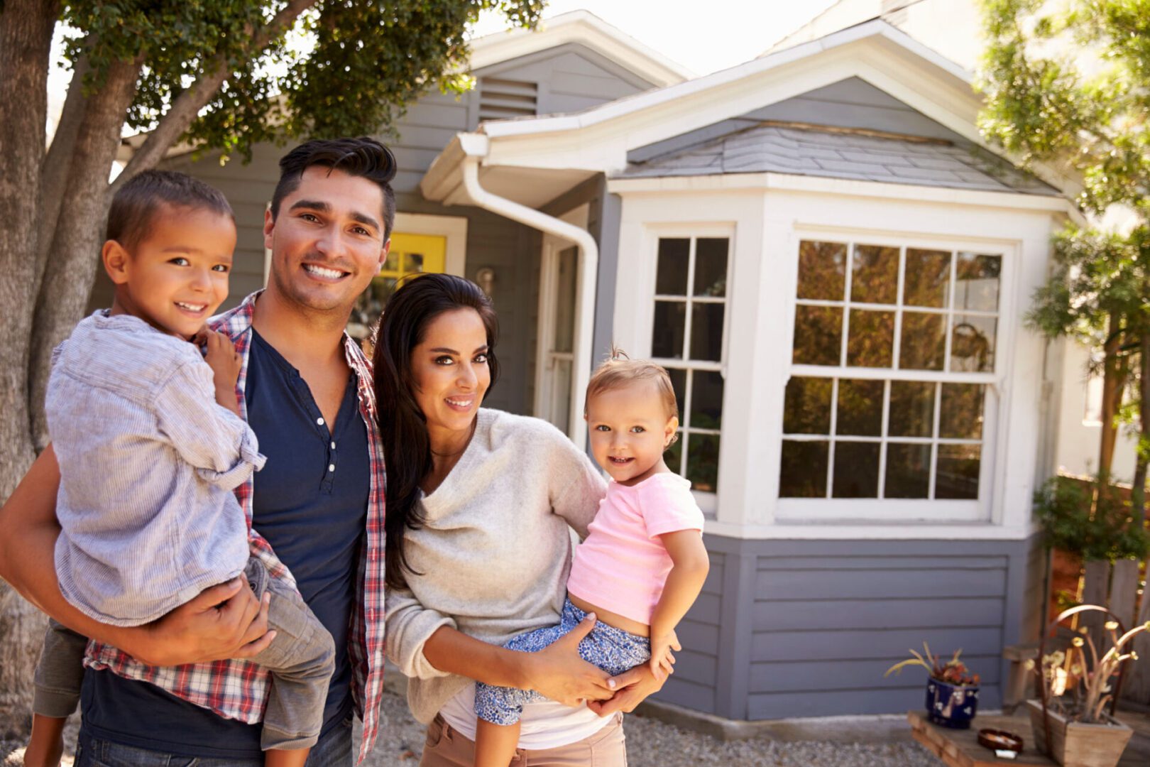 Happy family standing in front yard