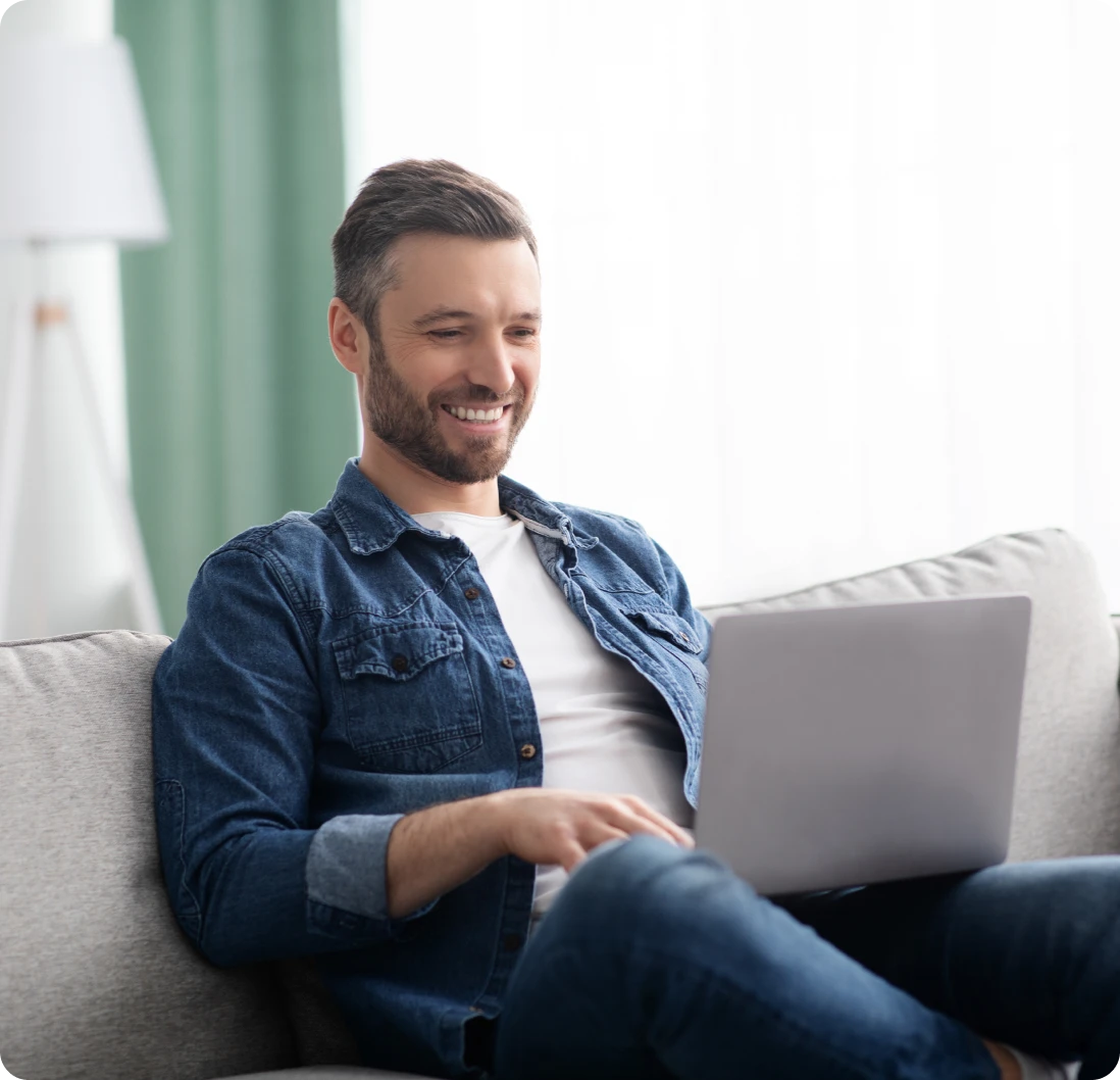 Relaxed man working on couch