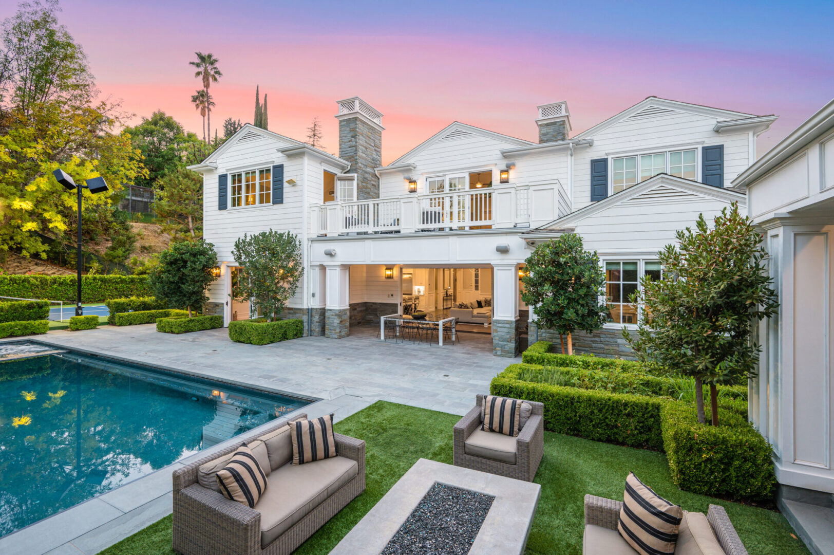 Luxury white house with pool and patio seating